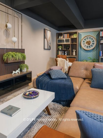This living area combines a comfortable leather sofa with a sleek white coffee table and a wood-paneled TV unit, demonstrating a perfect balance of textures and modern design.