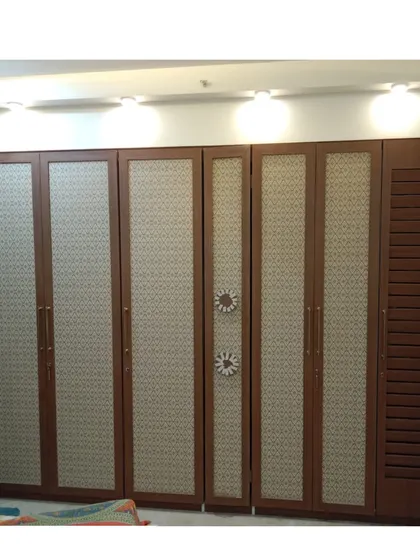 This floor-to-ceiling wardrobe shows how I can maximize storage in any bedroom. I used a combination of patterned and louvered shutters to add a unique decorative touch, creating a piece that is both a storage powerhouse and a design statement.