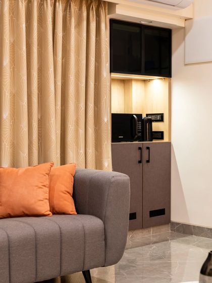 This shot shows how we integrated a compact pantry and coffee station into a niche in the living area. By tucking it away, we maintained a seamless wall line while adding significant functionality for entertaining or daily use.