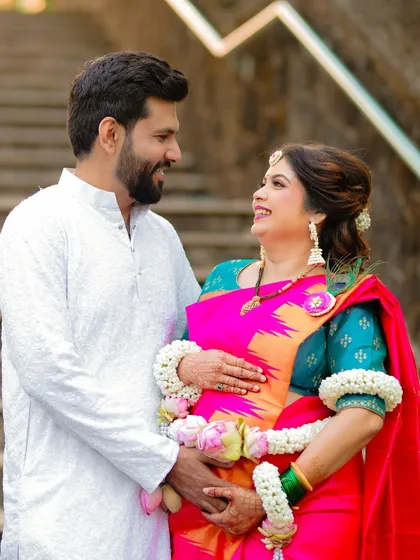 A beautiful portrait of an expecting couple during their traditional Dohale Jevan. The vibrant colors of their outfits and the genuine smiles make this a cherished memory.