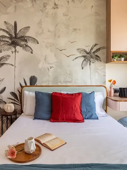 In this master bedroom, we blended romance and functionality. A custom botanical wallpaper creates a stunning feature wall, while the integrated study nook makes the most of a compact layout, proving that you never have to sacrifice style for practicality.