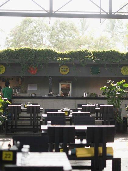 A duplicate shot of the indoor seating, reinforcing the bright, airy, and green atmosphere.