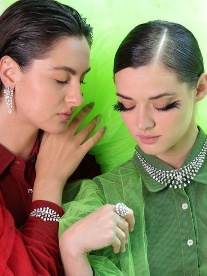 Another angle from the IGI shoot, capturing a moment of connection between the two models, draped in vibrant colors and sparkling diamonds.