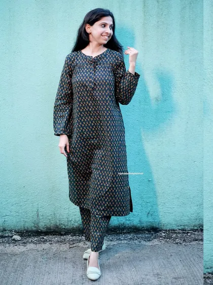 Prints that pop. This dark, intricately printed coord set is for those who love a bold and chic statement. The full-sleeved kurta adds a touch of sophistication.