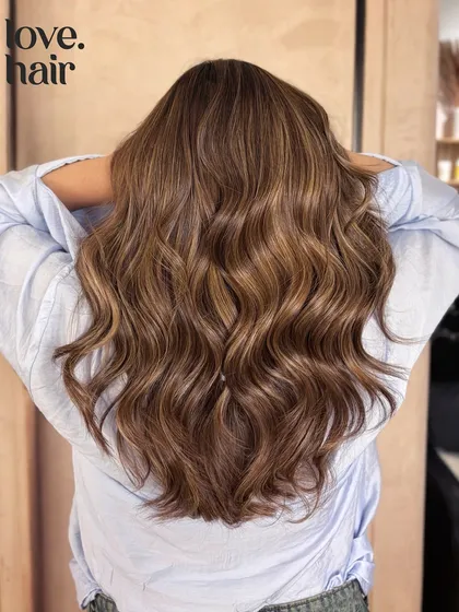 The back view of this perfect bronde balayage, showing off the long, healthy hair and expert color work.