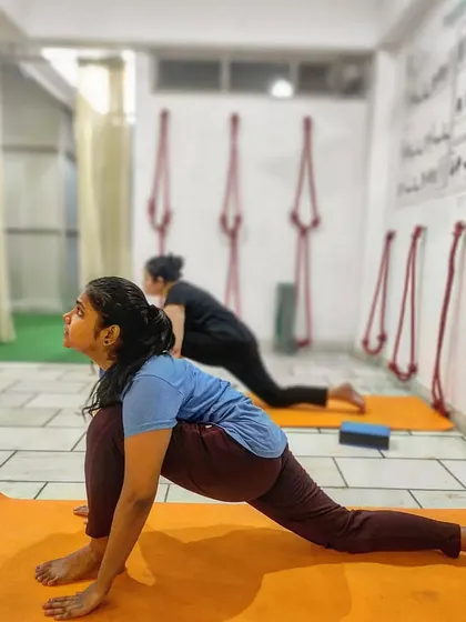 This image highlights the benefits of Ashwa Sanchalanasana (Equestrian Pose), a pose that builds lower-body strength and flexibility.