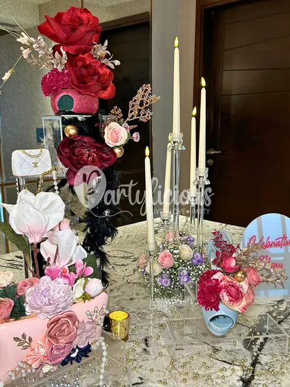 A luxurious and glamorous table corner, featuring tall candelabras, lush floral arrangements, and chic, fashion-inspired details.
