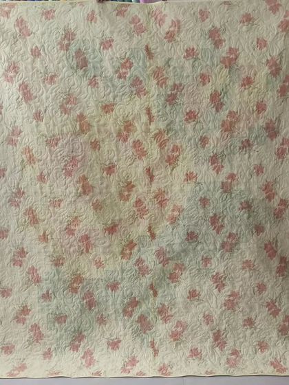 The back of the sunset-colored pixelated rose quilt.