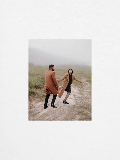 A minimalist composition featuring the couple walking hand-in-hand on a misty path in Meghalaya. The simplicity of the shot emphasizes their connection and the feeling of embarking on a journey together.