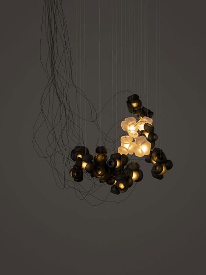 Another view of the Bocci 100 chandelier, showcasing its sprawling, organic form and the interplay of light and shadow.