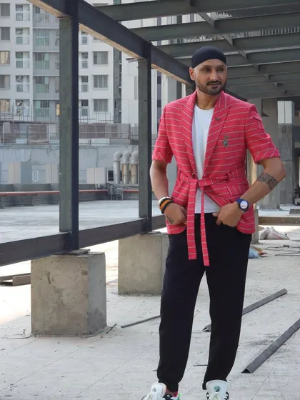 The true Indian blood. Harbhajan Singh in a custom red striped blazer with a modern, relaxed fit. This look is dapper, defined, and perfect for a style icon.