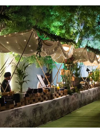 A beautifully designed row of live food stations under a canopy, creating an elegant and organized food street experience for guests.