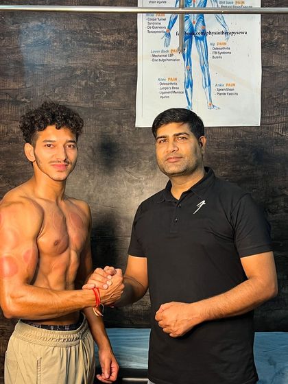 Shaking hands with athlete Kartik after his treatment.