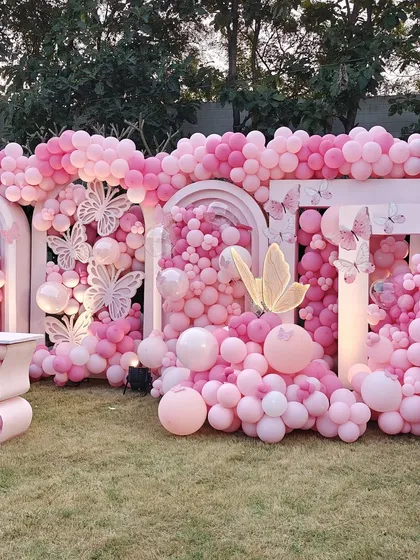 We created this breathtaking wall of pink balloons for an unforgettable outdoor event. This massive installation features thousands of balloons in varying shades and sizes, accented with intricate butterfly cutouts to create a stunning, textured backdrop perfect for photos.