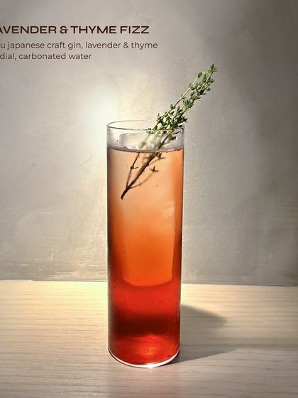 The Lavender & Thyme Fizz, a floral and herbaceous gin cocktail from our Suntory menu. Roku gin is paired with a house-made cordial for a delicate, bubbly drink.