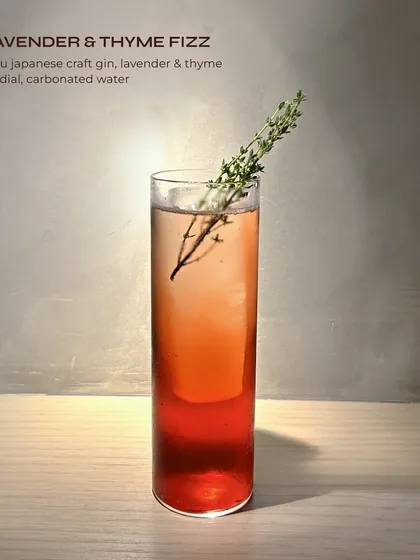The Lavender & Thyme Fizz, a floral and herbaceous gin cocktail from our Suntory menu. Roku gin is paired with a house-made cordial for a delicate, bubbly drink.