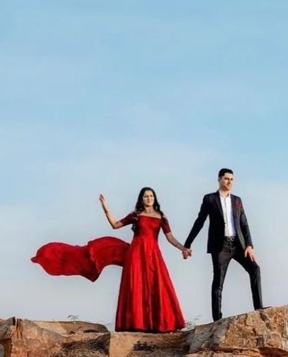 A dramatic pre-wedding shoot featuring a couple and our flowing red gown. This is the kind of epic shot you can create with our photoshoot-ready outfits.