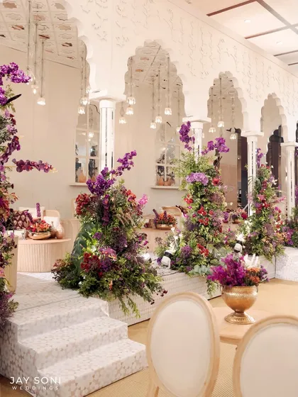 An angled view of the multi-level lounge area, showcasing the thoughtful placement of floral decor and seating to create depth and visual interest.