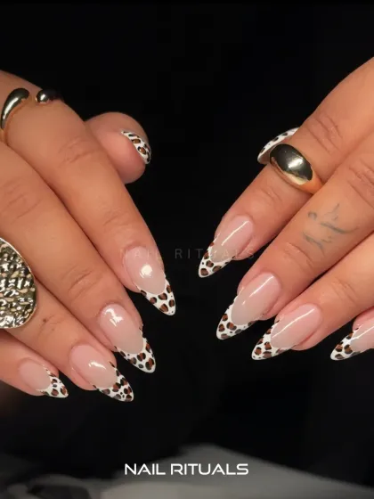 Another look at these fierce cow print nails. The sharp almond shape and classic pattern create a bold and stylish statement.