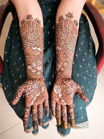 Another view of the floral mandala design, showing the symmetry on both hands.