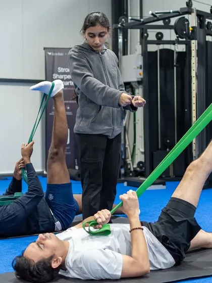 Guided stretching with resistance bands is a key part of our rehab and recovery protocols. A physiotherapist assists clients to ensure they achieve the correct position and intensity for effective mobility work.