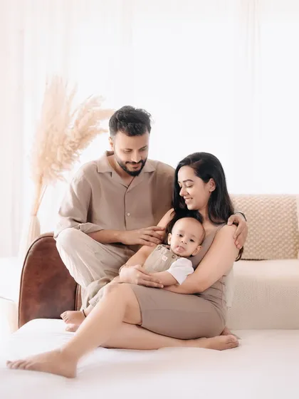 A quiet, loving moment between parents and their baby. The soft, gentle interaction in this photo speaks volumes about their new journey together.