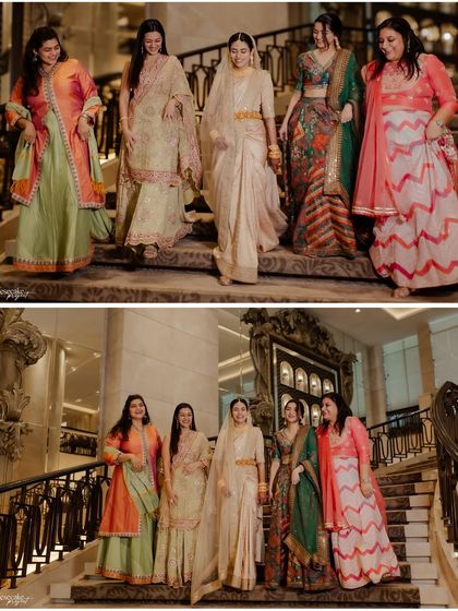 The bride and her bridesmaids making a stylish entrance down the grand staircase.