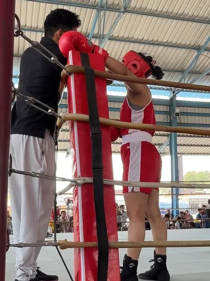 Coaching one of our female fighters in the corner during the championships. I am proud to train dedicated athletes, both men and women.
