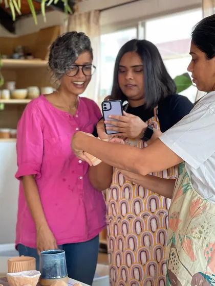 A moment of modern learning, as students use a phone to capture a detail or technique during a class.