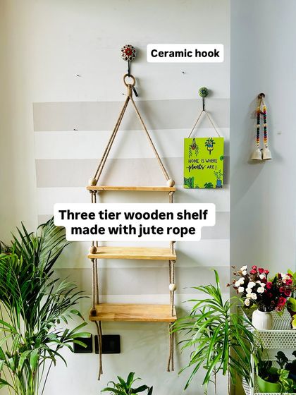 Beauty in simplicity. This three-tier wooden shelf is made with sturdy jute rope and large wooden beads, providing ample space for your favorite plants. It comes with a ceramic wall hook and six ceramic planters to complete the look.