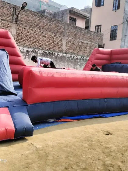This is our inflatable 'Baller Game', inspired by TV game shows. Participants try to run across a series of large inflatable balls, providing a fun and challenging experience for older kids and adults at events and adventure parks.