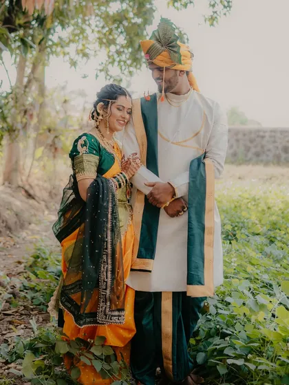 A tender moment with the bride resting on the groom's shoulder. This pose conveys a sense of comfort, trust, and affection between the couple.