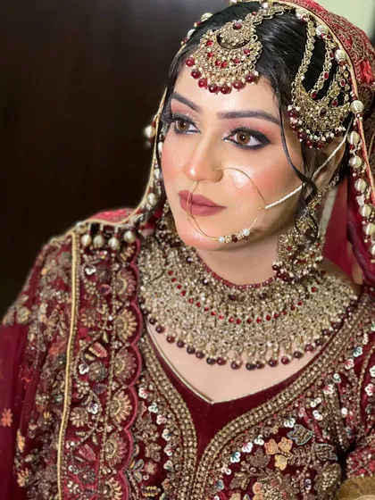 A portrait that captures the grandeur of the full bridal look. The makeup is bold and defined, perfect for a bride who wants to make a statement.