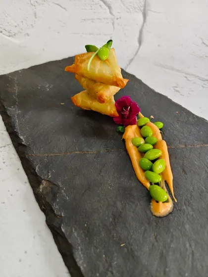 This is where tradition meets innovation. Our Edamame Truffle Samosas feature a golden, crispy pastry filled with creamy edamame and a hint of earthy truffle, creating a bite that is both familiar and surprisingly new.