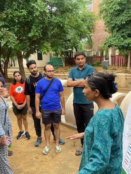 Our team explains the Aravali Creek restoration project to the Salesforce volunteers, using a map to show the creek's role in the city's water management system.