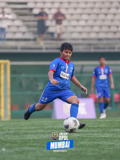 A young player focused on the ball, demonstrating excellent technique.