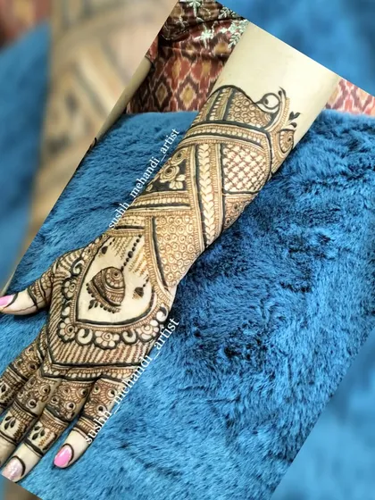 A happy client showing off her party mehandi. This design is a perfect example of a beautiful, balanced pattern for any celebration.