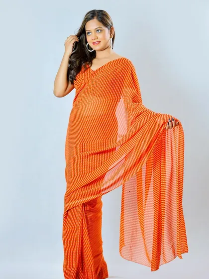 A studio shot featuring a vibrant orange striped saree, demonstrating my ability to shoot traditional wear for fashion lookbooks.