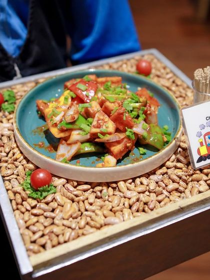 Our catering options include delicious appetizers for adult guests, like this beautifully presented Chilli Paneer Dry, ensuring everyone has something tasty to enjoy.