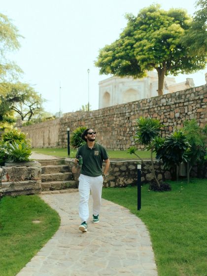 A full-length shot of me walking through a park in Delhi. This photo places the brand's apparel in an urban nature setting, highlighting its versatility for city dwellers who love the outdoors.