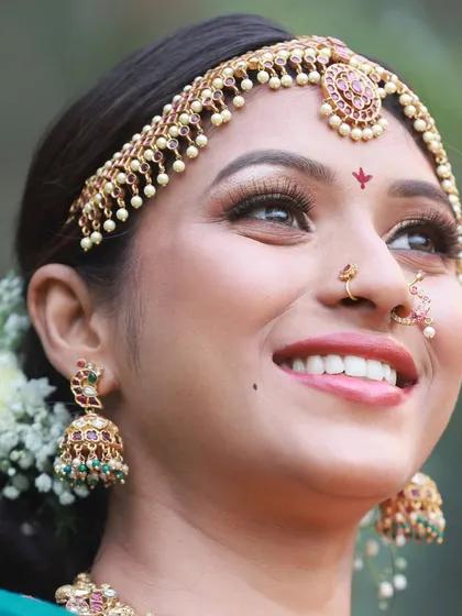 Capturing pure joy and laughter is always a goal. This candid shot from our bridal saree collaboration highlights the model's smile and the intricate details of her 'jhumka' earrings.