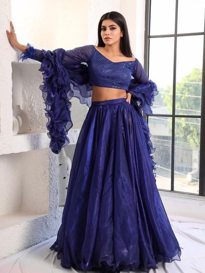 A confident pose in the royal blue lehenga. This outfit is designed for the woman who isn't afraid to make a statement with her style.