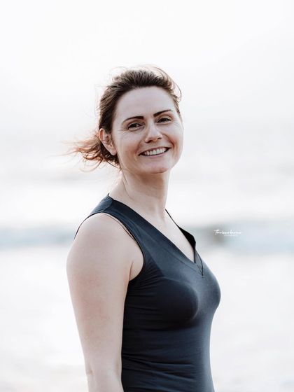 A simple, happy portrait on the beach. The natural smile and soft background make this a warm and inviting image.