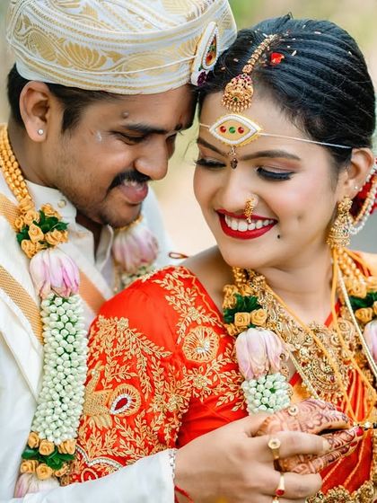 An intimate and tender portrait of a newly married couple. The groom's embrace and the bride's happy, dimpled smile make this a truly special moment.