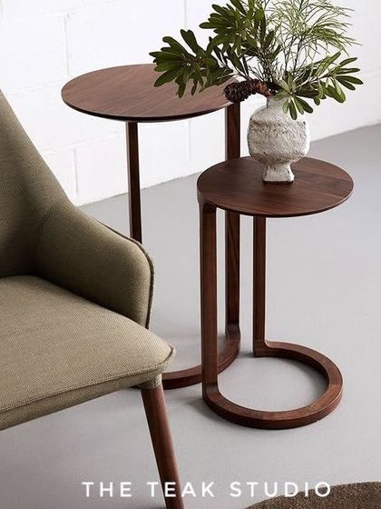 An inspiration image showing a pair of modern nesting side tables. The C-shaped design of the smaller table allows it to tuck neatly beside a sofa or chair, making it a versatile and space-saving option.
