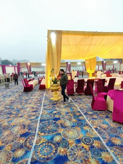 This wide view shows the scale of an outdoor wedding setup. You can see the large tented area with guest seating and the long line of buffet tables, demonstrating how I manage decor, furniture, and catering arrangements together.