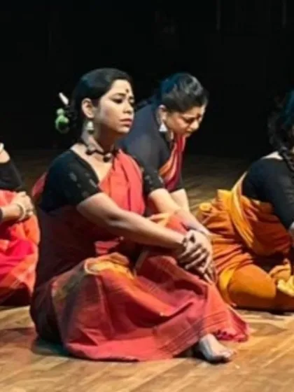The dancers in 'Songs of the Millstone' listen intently, embodying the characters of women whose stories are often unheard. The production uses simple, earthy costumes to keep the focus on the narrative and emotion.