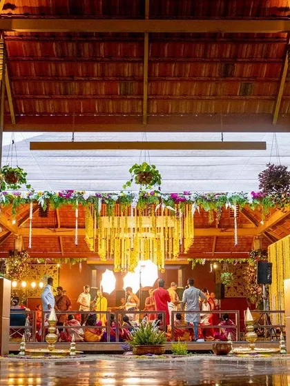 The full expanse of the wedding venue, showcasing the traditional architecture complemented by our custom decor, including pillar wraps and floral arrangements.