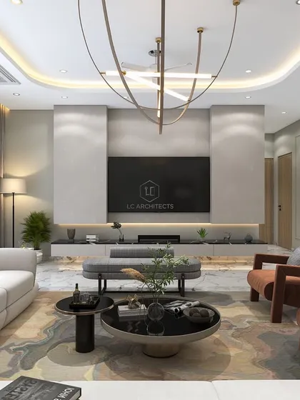 This living room design concept uses a large white sofa and warm wood armchairs to create a balanced look. The focal point is the minimalist TV unit set against a textured wall, with a modern chandelier adding a sculptural element.