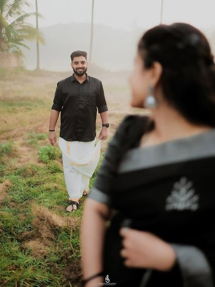 A creative shot with her in the foreground, looking towards him. This perspective creates a sense of anticipation and story.